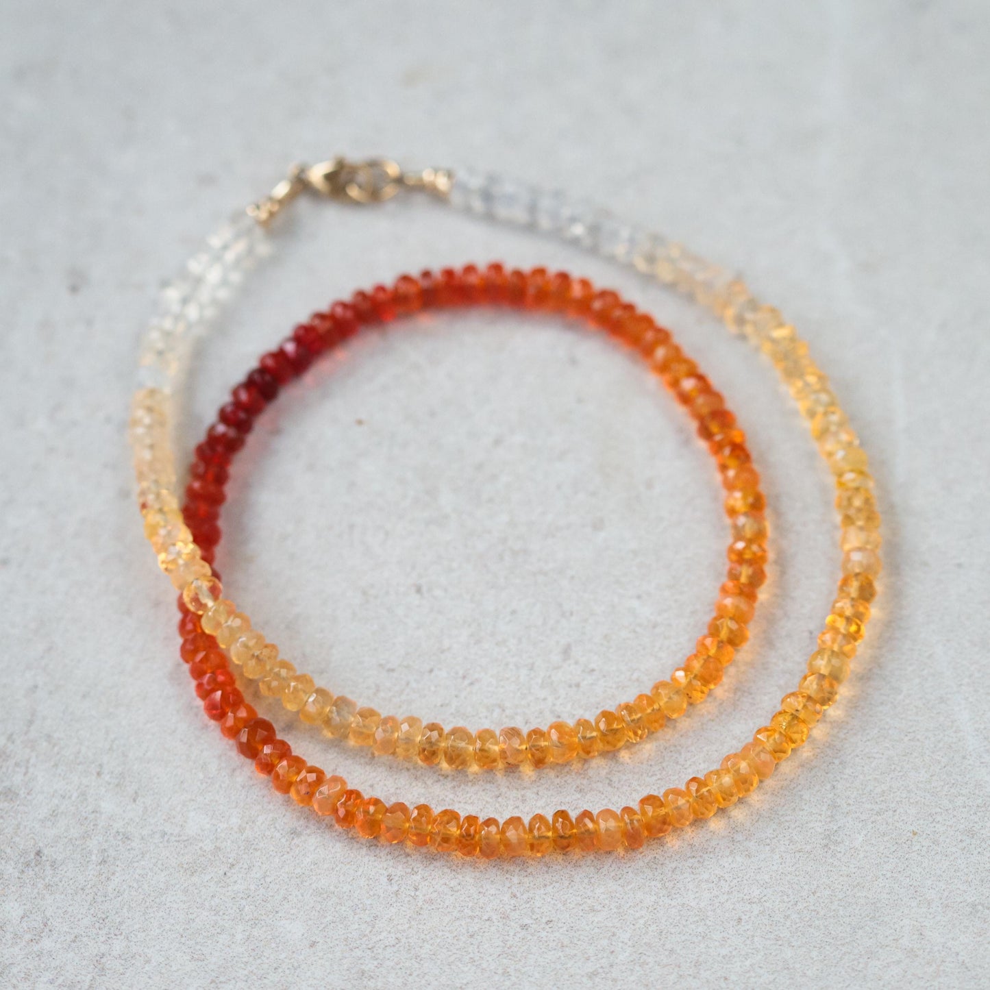 Mexican fire opal necklace with 14K gold setting from Earthly Abundance, showcasing vibrant orange and red gemstone pendant.