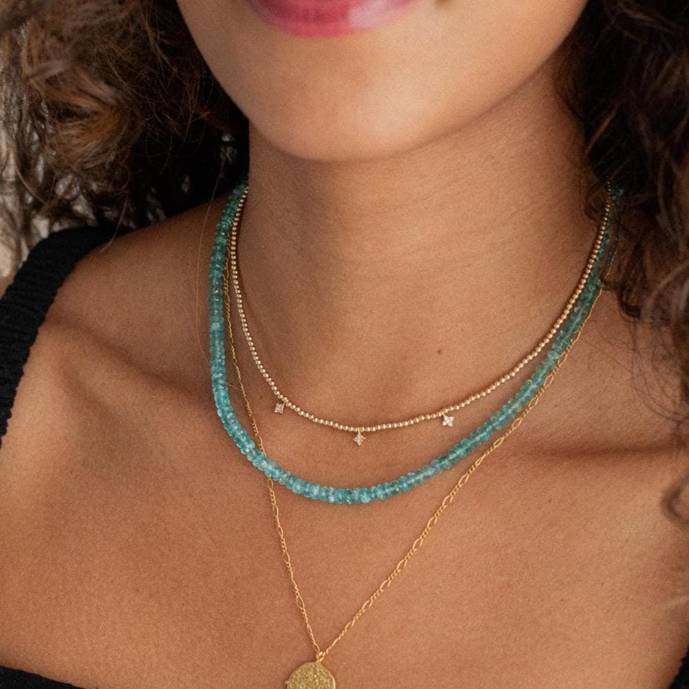 Bi-color apatite necklace with 14K gold chain from Earthly Abundance, featuring vibrant blue and green stones.