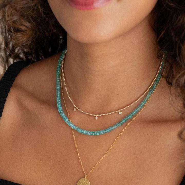 Bi-color apatite necklace with 14K gold chain from Earthly Abundance, featuring vibrant blue and green stones.