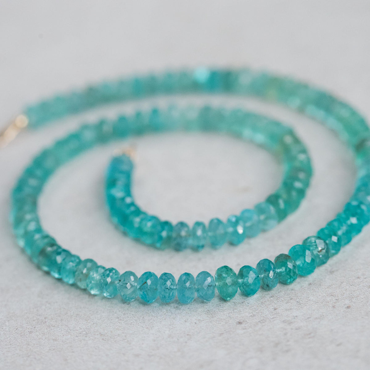 Bi-color apatite necklace in 14K gold chain, featuring vibrant blue and green stones, from Earthly Abundance.