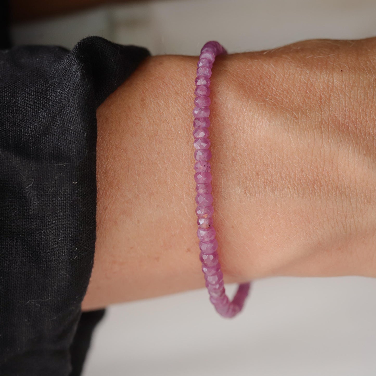 Earthly Abundance Rosata African Ruby bracelet featuring polished red ruby beads on a delicate elastic band.