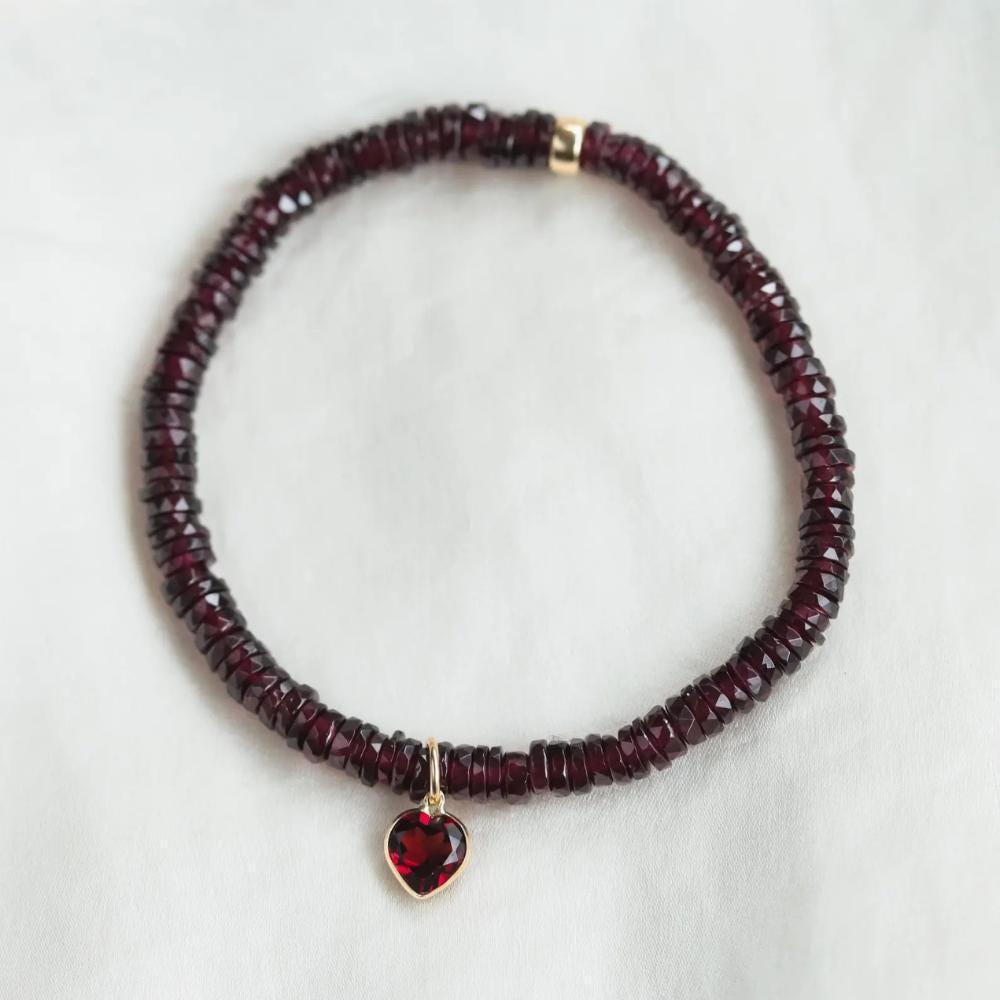 Earthly Abundance garnet heart bracelet featuring polished red gemstone hearts on a delicate chain.
