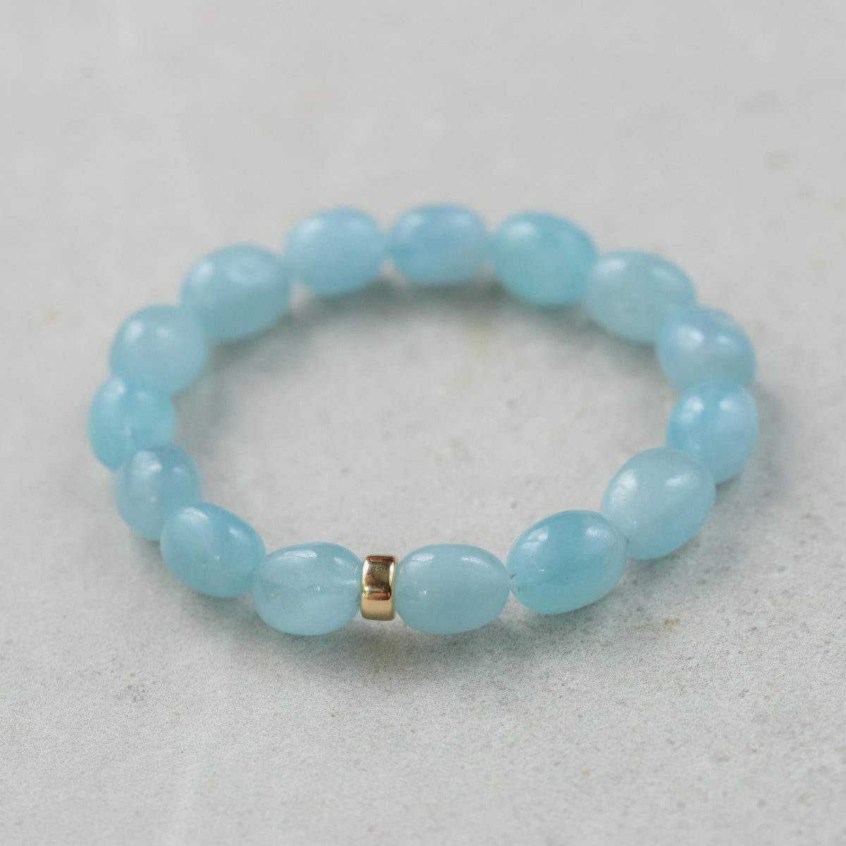 Aquamarine nugget bracelet with 14K gold clasp, featuring polished aquamarine stones on a delicate gold chain.
