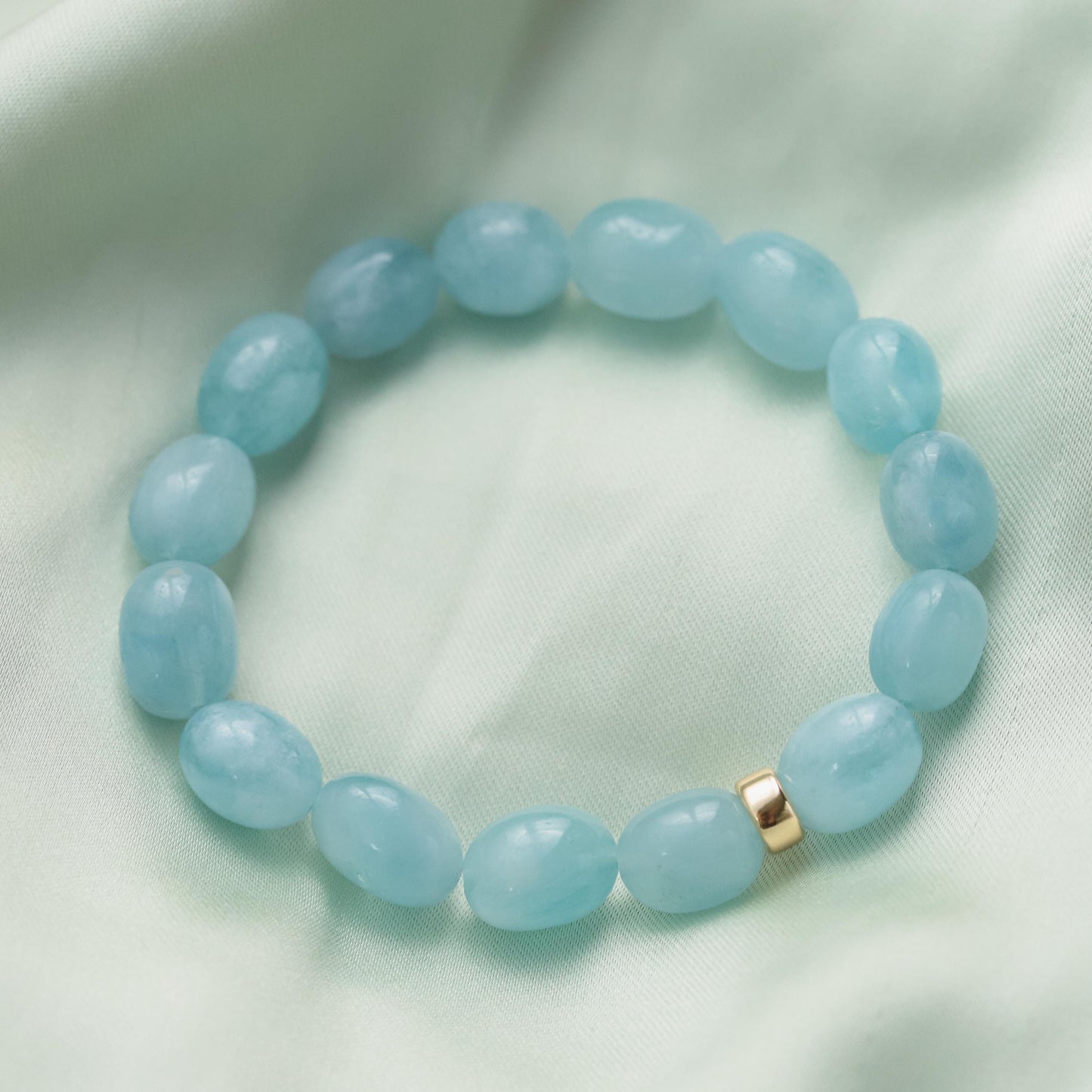 Earthly Abundance aquamarine nugget bracelet with 14K gold clasp, featuring polished blue gemstone nuggets on a delicate chain.