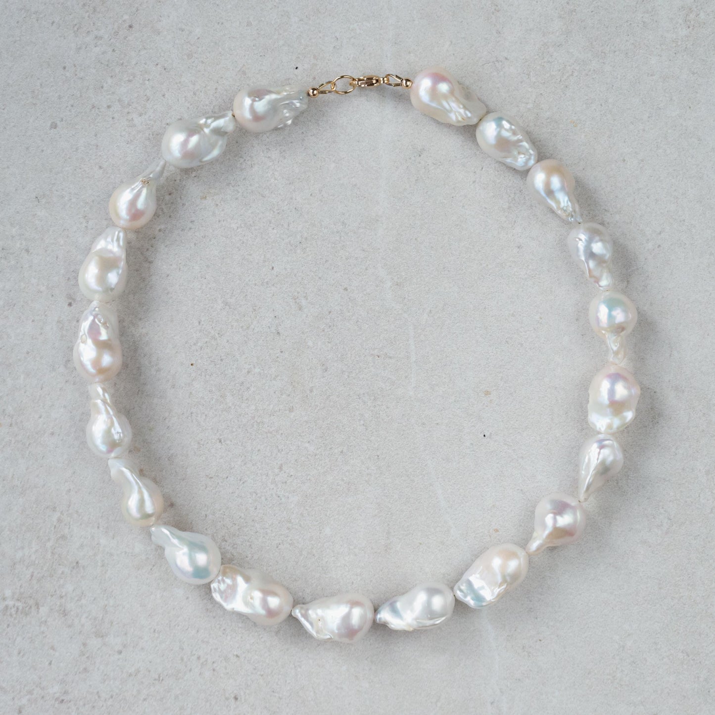 Elegant Baroque Pearl necklace by Earthly Abundance featuring irregularly shaped lustrous pearls on a delicate chain.