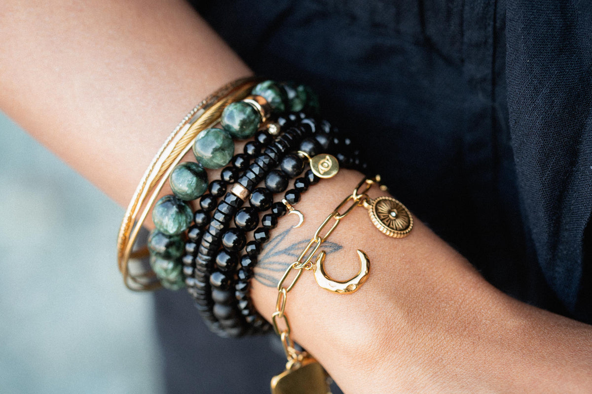 Black spinel heart bracelet with 14K gold accents from Earthly Abundance featuring a delicate chain and heart-shaped charms.