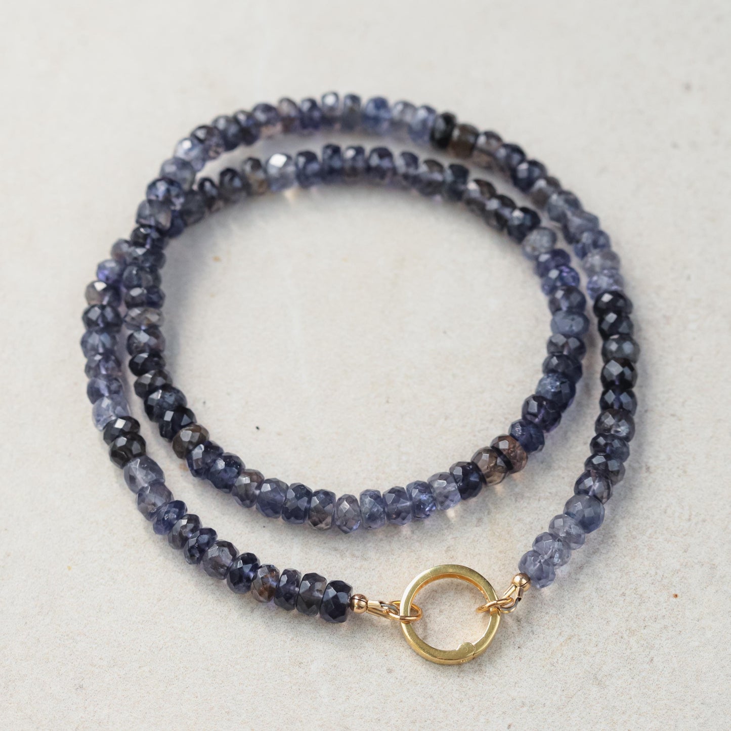 Ombre Iolite Carabiner Necklace featuring a gradient blue-purple Iolite stone on a silver-toned chain by Earthly Abundance