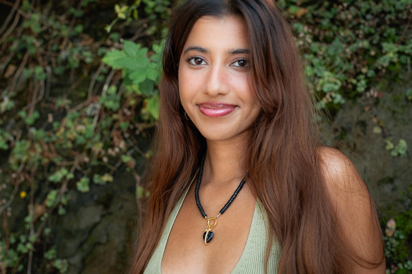 Black spinel and topaz heart pendant necklace by Earthly Abundance with a delicate chain and sparkling gemstones.