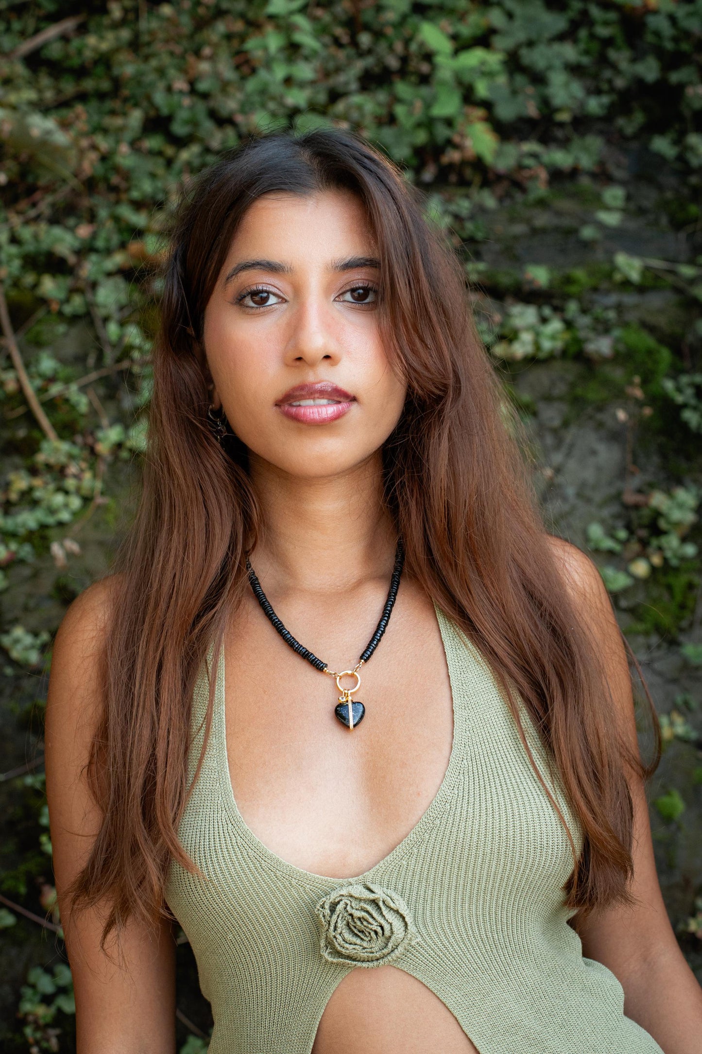 Black spinel and topaz heart necklace featuring dark gemstones on a delicate chain, crafted by Earthly Abundance.