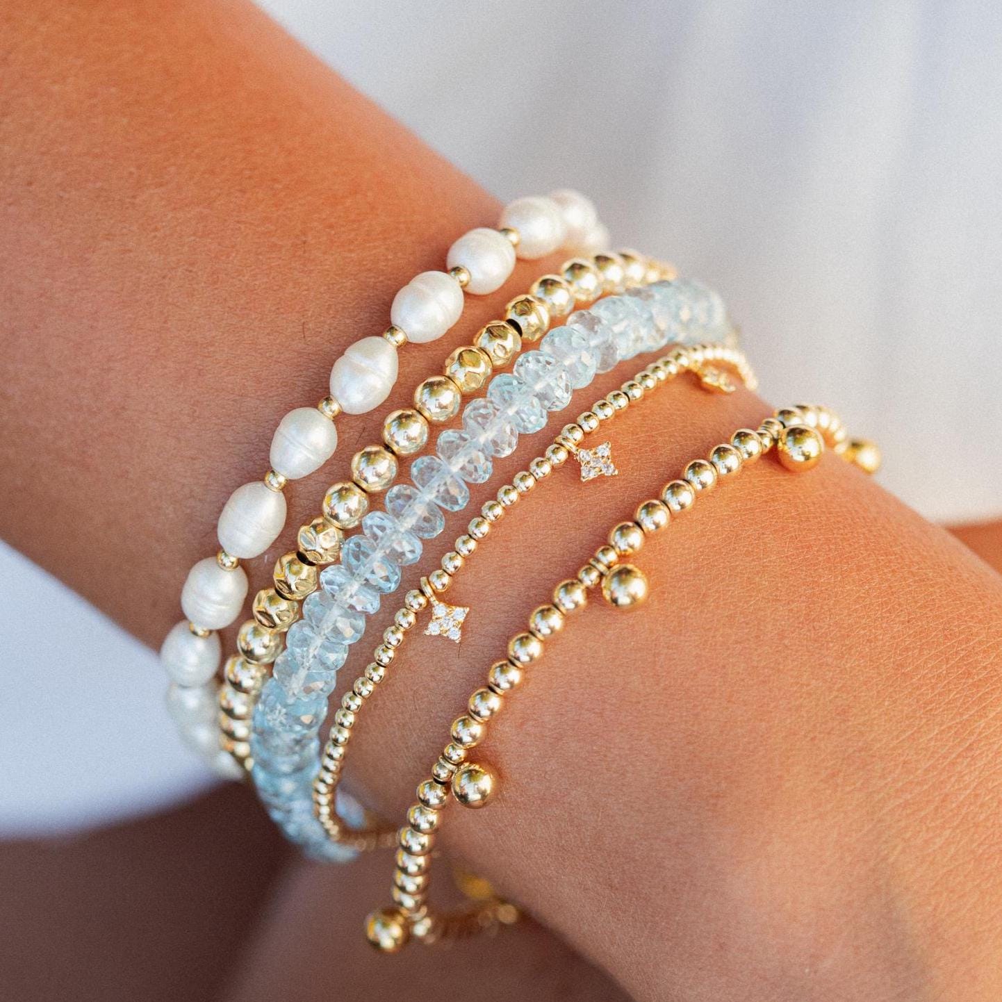 Swiss Blue Topaz bracelet with 14K gold setting by Earthly Abundance, showcasing sparkling blue gemstones on a delicate chain.