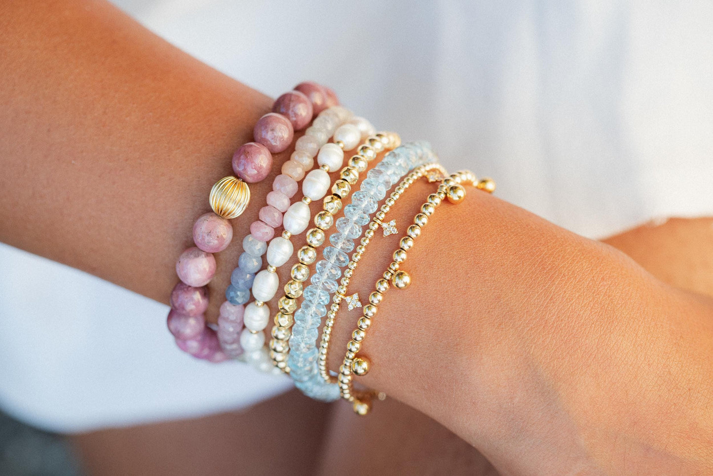 Swiss Blue Topaz bracelet featuring 14K gold setting with sparkling blue gemstones, crafted by Earthly Abundance.