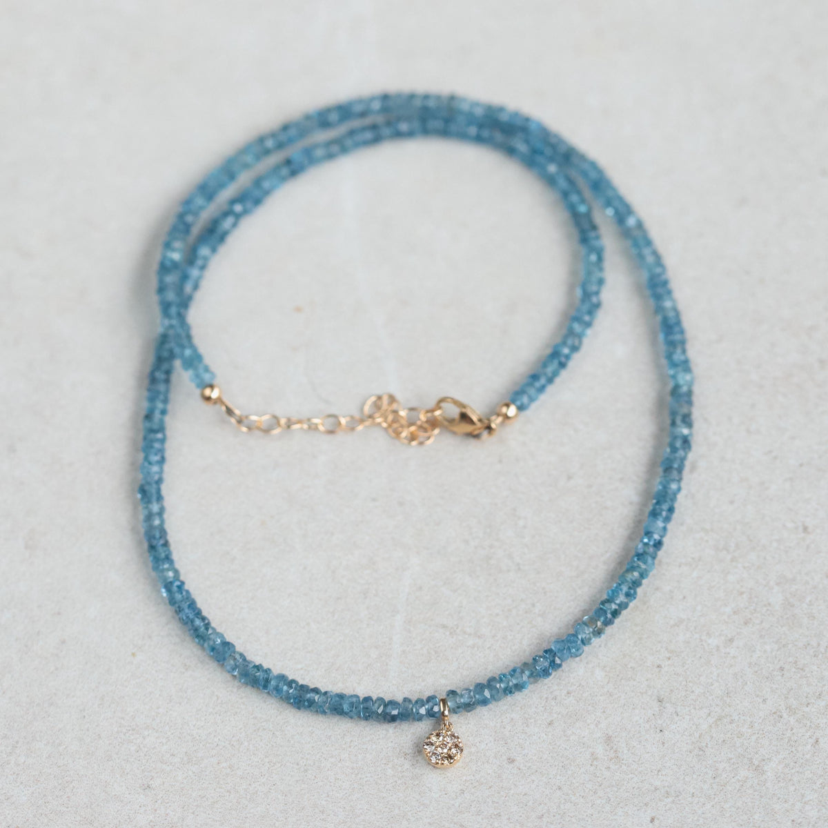 Santa Maria aquamarine diamond necklace featuring a central aquamarine gemstone with diamond accents on a silver chain.