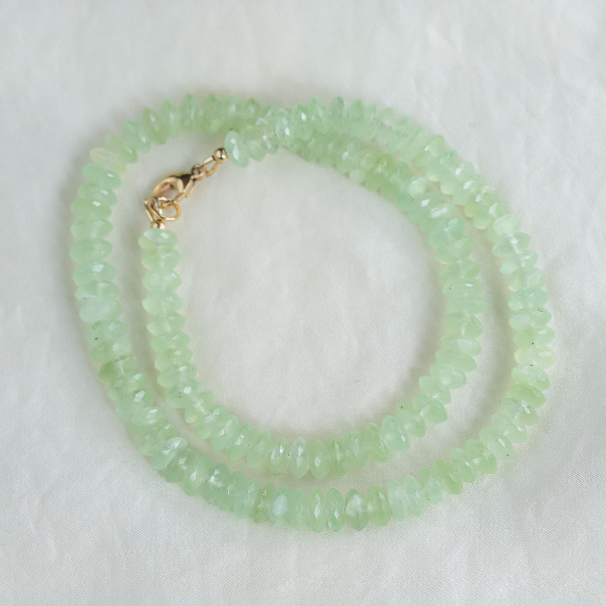 Prehnite necklace with 14K gold chain from Earthly Abundance, featuring a polished green gemstone pendant.