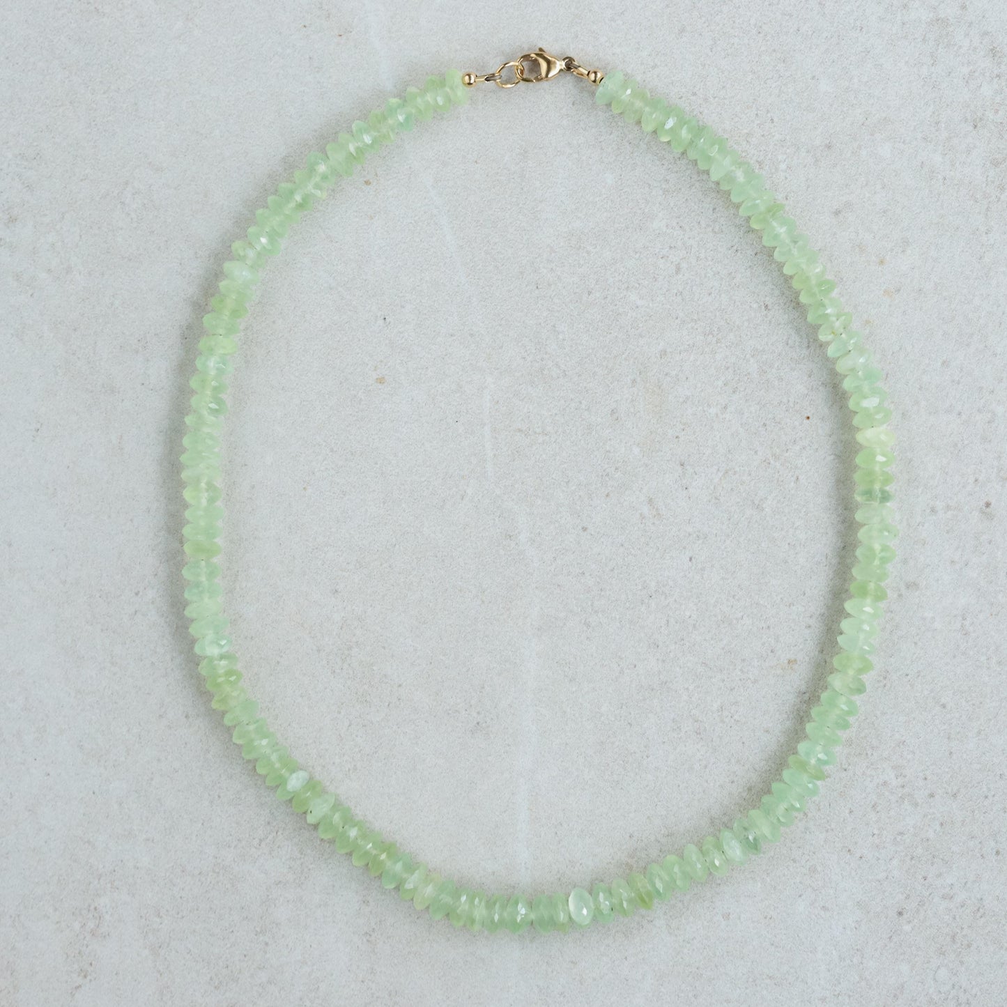 Prehnite necklace with 14K gold chain, featuring a smooth green gemstone pendant, by Earthly Abundance.
