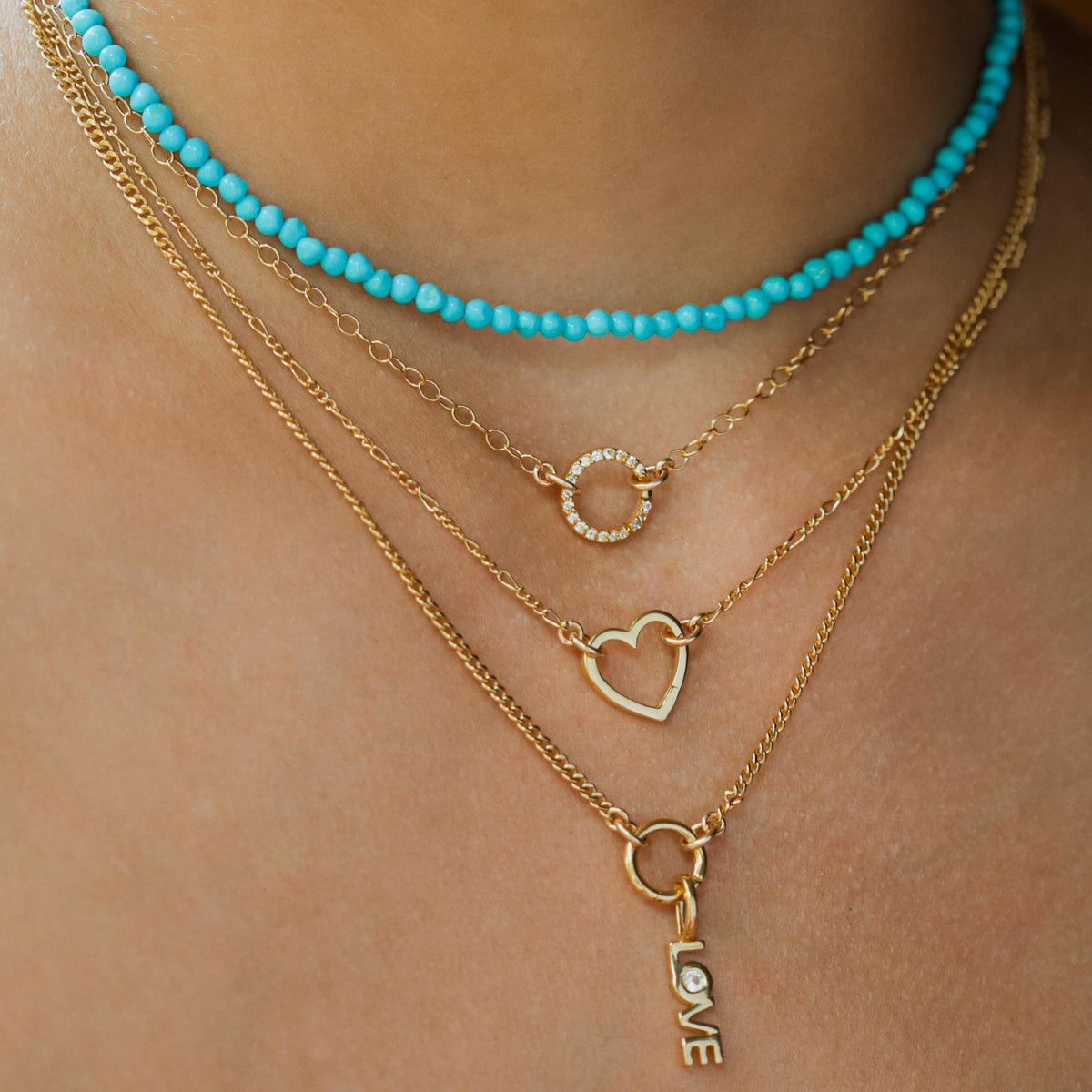 14k gold-filled Figaro chain necklace by Earthly Abundance, showcasing its layered, polished links on a neutral background.