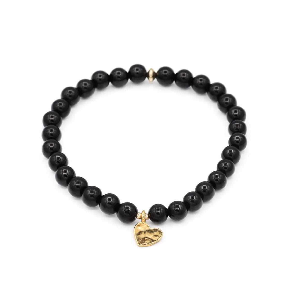 Black Tourmaline Heart from Earthly Abundance showing a polished black crystal in the shape of a heart.