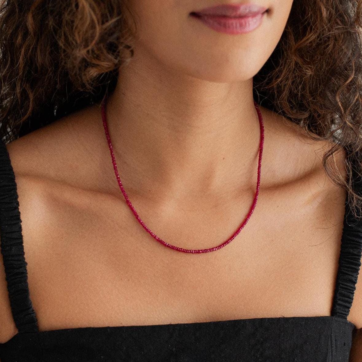 Carmine Longido Ruby Necklace featuring vibrant red rubies on a delicate gold chain from Earthly Abundance.