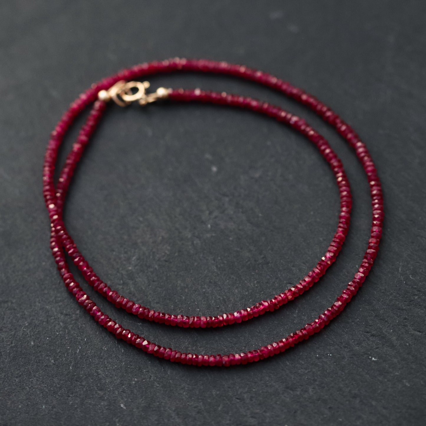Carmine Longido Ruby Necklace featuring vibrant red gemstones on a delicate chain, from Earthly Abundance.