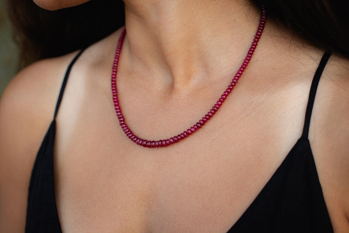 Elegant Crown Longido Ruby Necklace in 14K gold by Earthly Abundance, featuring a vibrant red ruby pendant on a delicate chain.