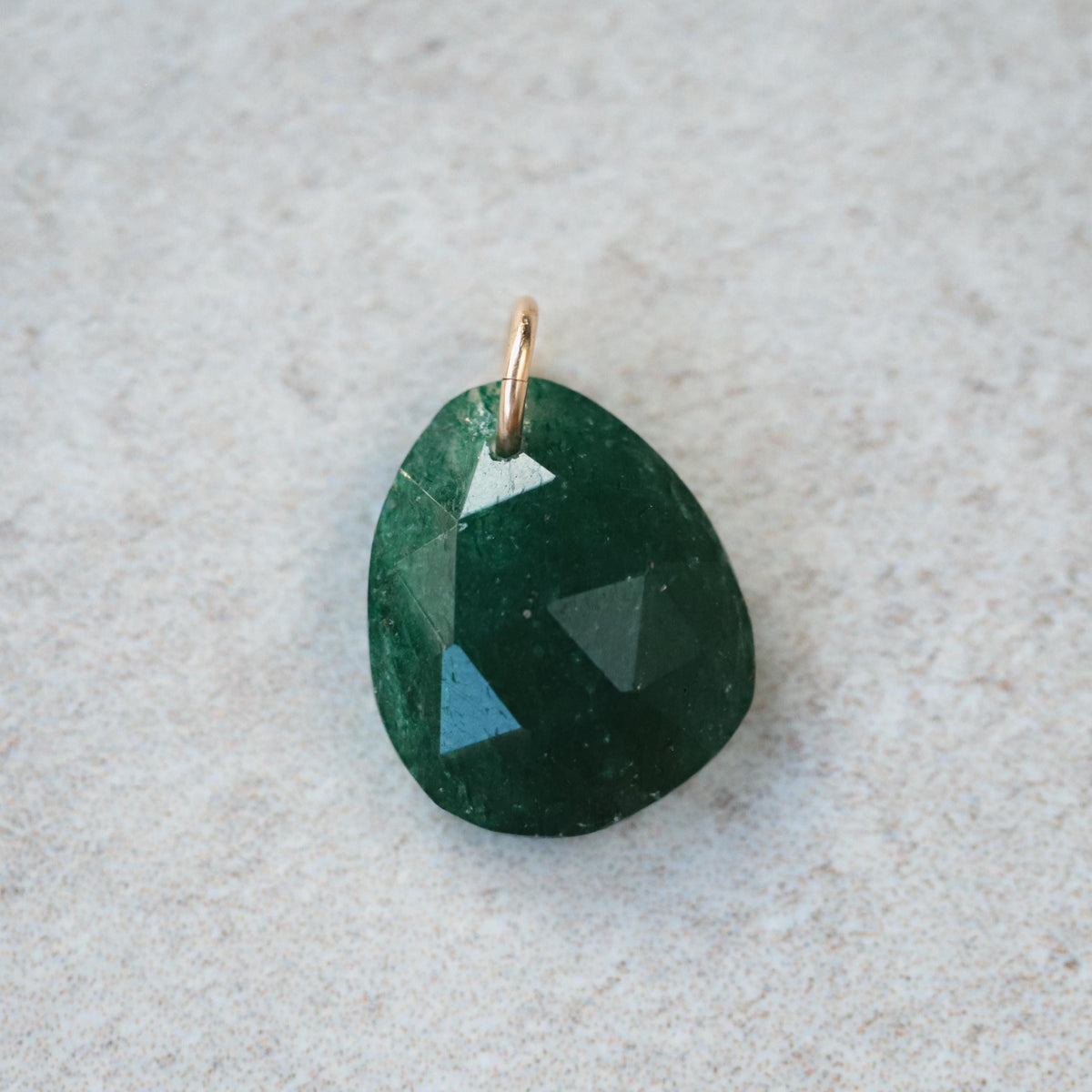 Green aventurine pendant in 14K gold setting, showcasing a polished, oval-shaped gemstone with a gold bail for chain attachment.