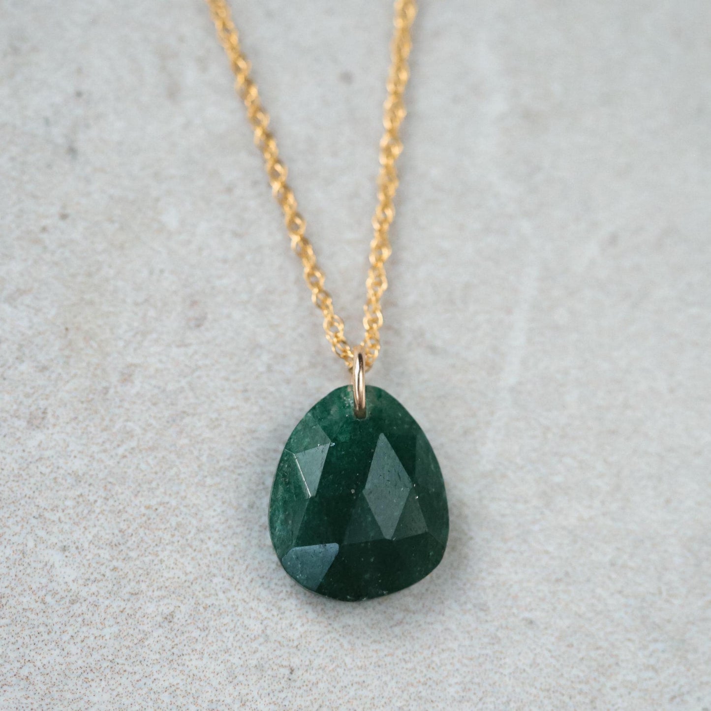 Green aventurine pendant in 14K gold setting, featuring a polished gemstone on a delicate chain.