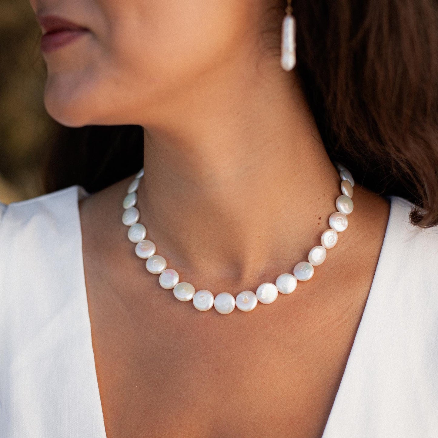 Freshwater disc pearl necklace by Earthly Abundance featuring smooth, round pearls on a delicate chain.