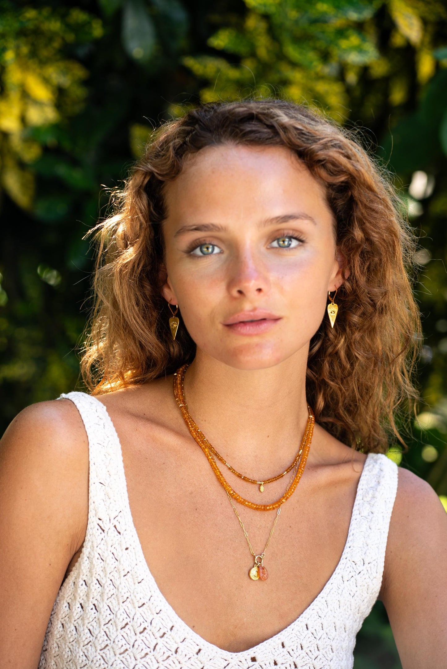 Spessartite Garnet necklace with 14K gold setting, featuring vibrant orange-red gemstones on a delicate chain.