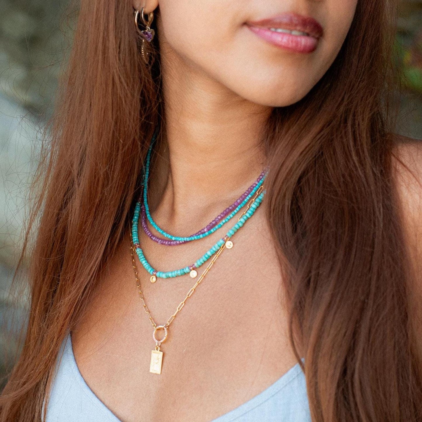 Rosata African Ruby Necklace by Earthly Abundance featuring vibrant red ruby beads and silver clasp on a delicate chain.