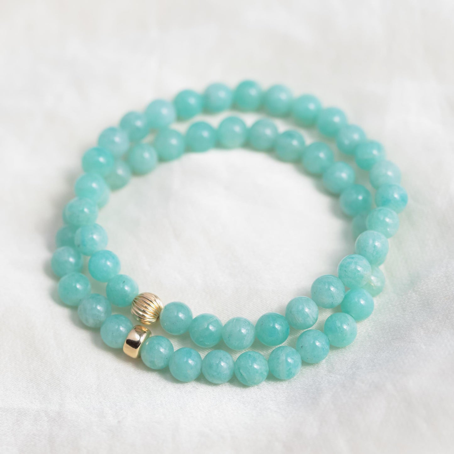 Brazilian Amazonite bracelet with 6mm beads from Earthly Abundance, showcasing vibrant blue-green gemstones on a white background.
