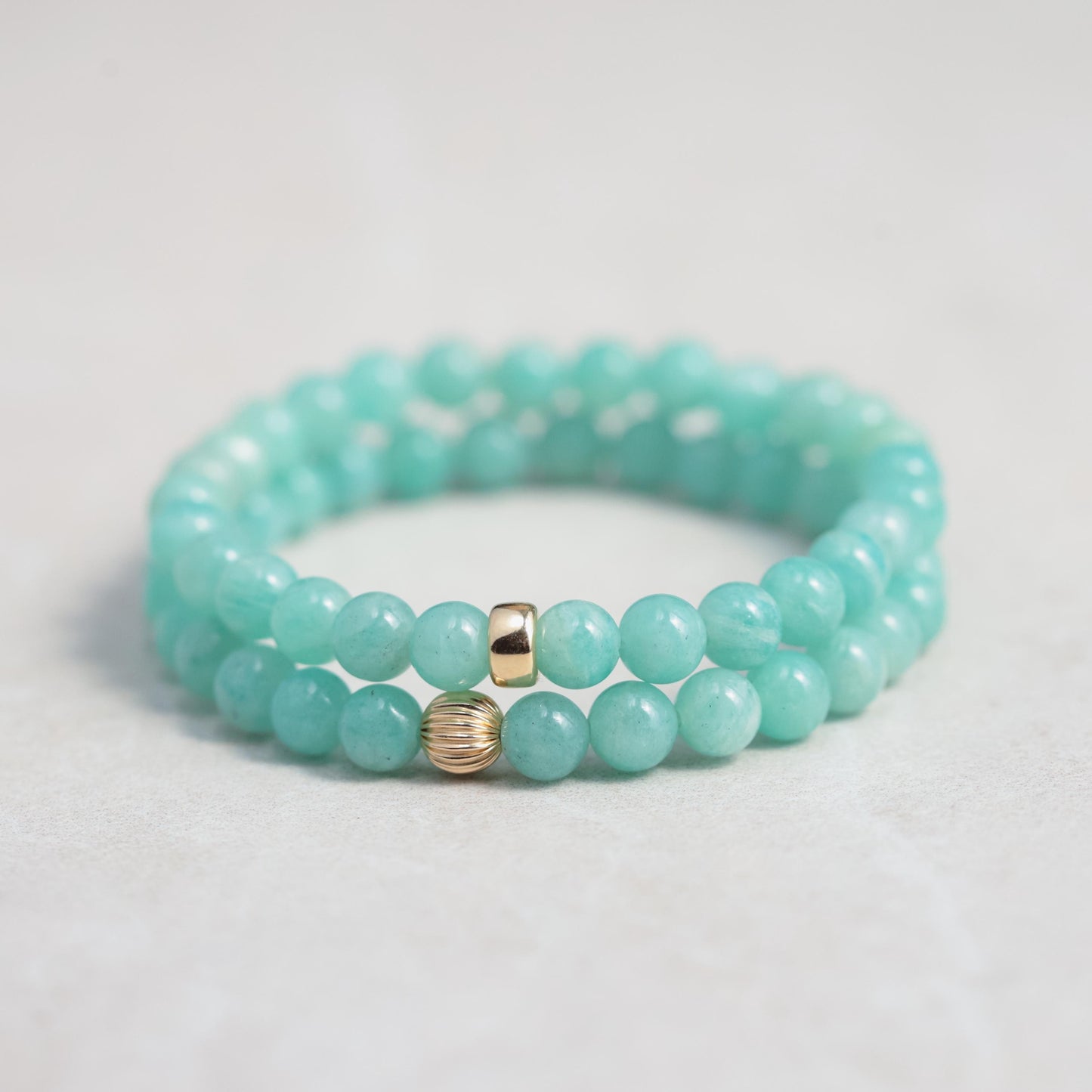 6mm Brazilian Amazonite bracelet by Earthly Abundance featuring smooth blue-green stones on an elastic band.