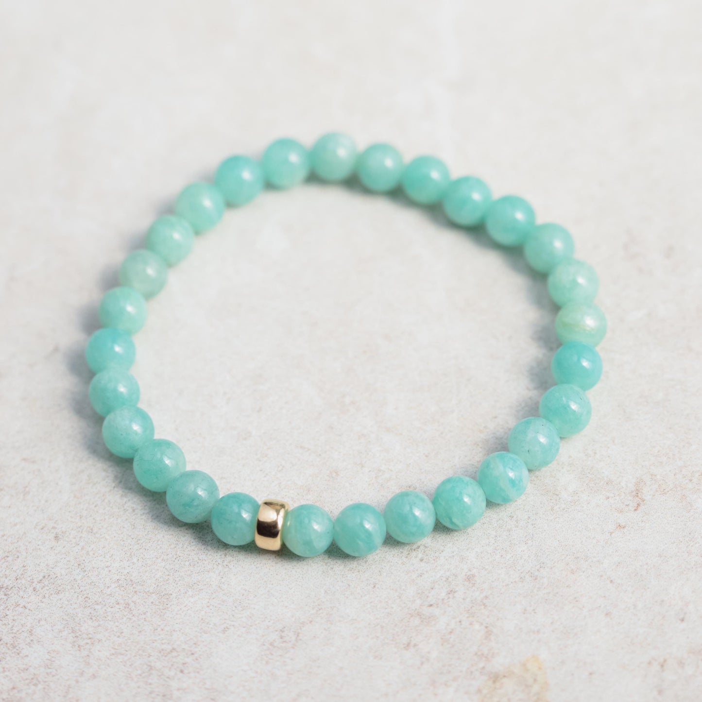 Sixmm Brazilian Amazonite bracelet with polished blue-green stones, featuring a natural stone clasp, by Earthly Abundance.