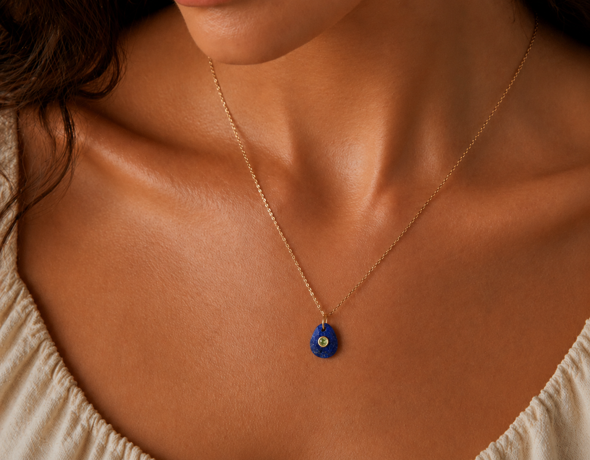 Velvet Sky Pendant Necklace featuring Lapis and Peridot gemstones from Earthly Abundance, showcasing a delicate gold chain and vibrant stones.