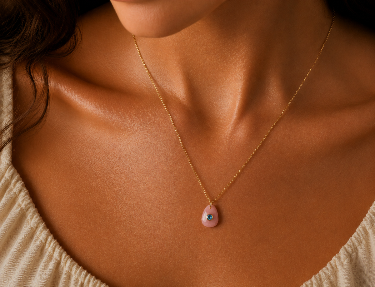 Bluebird pendant featuring pink opal and Swiss blue topaz gemstones, crafted by Earthly Abundance.