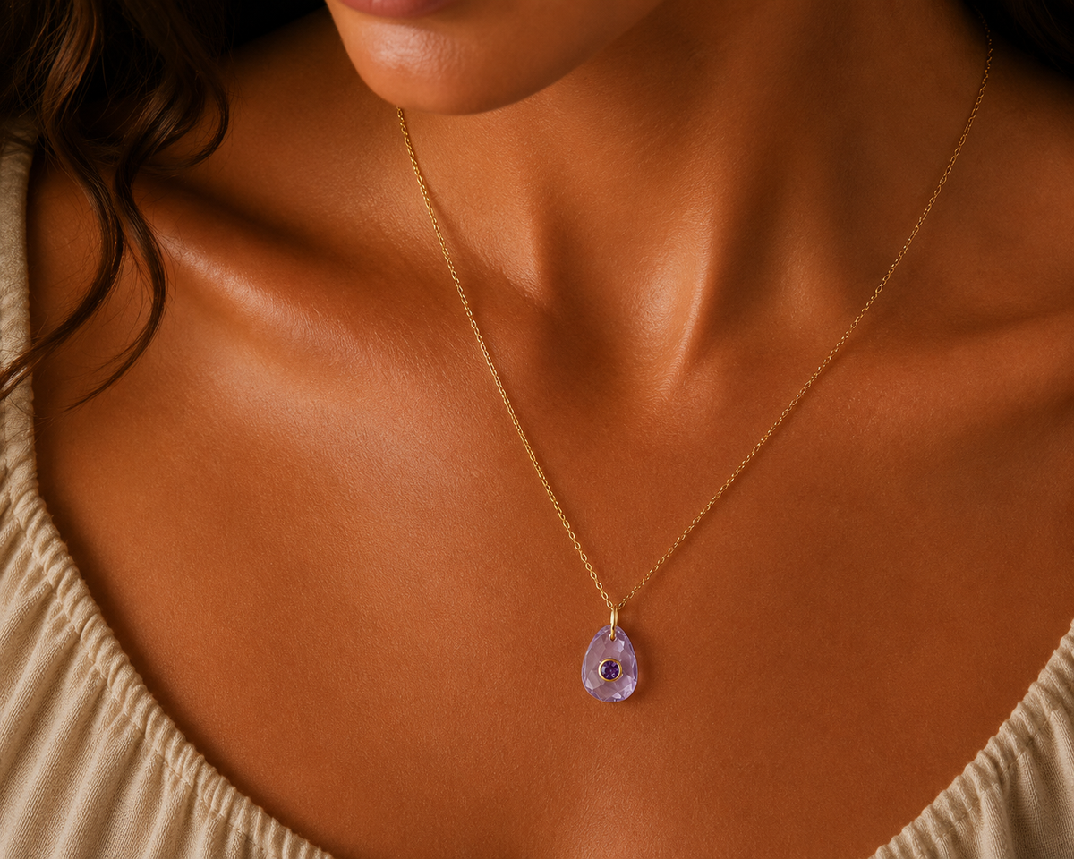 Violet Muse Amethyst Pendant Necklace by Earthly Abundance featuring a polished purple amethyst gemstone on a silver chain.