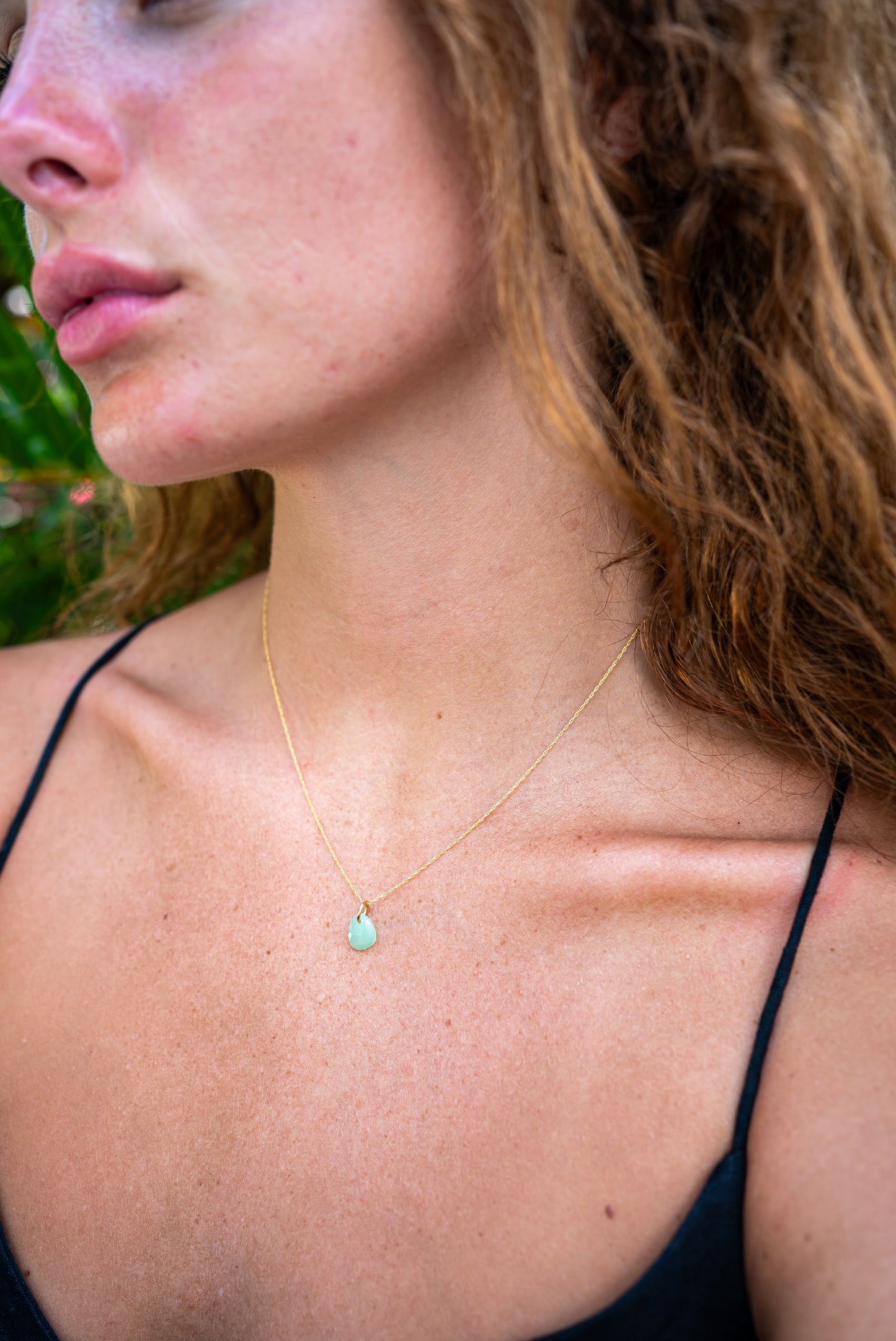 Electric green chrysoprase pendant necklace in 14K gold, featuring a polished, teardrop-shaped stone on a delicate gold chain.