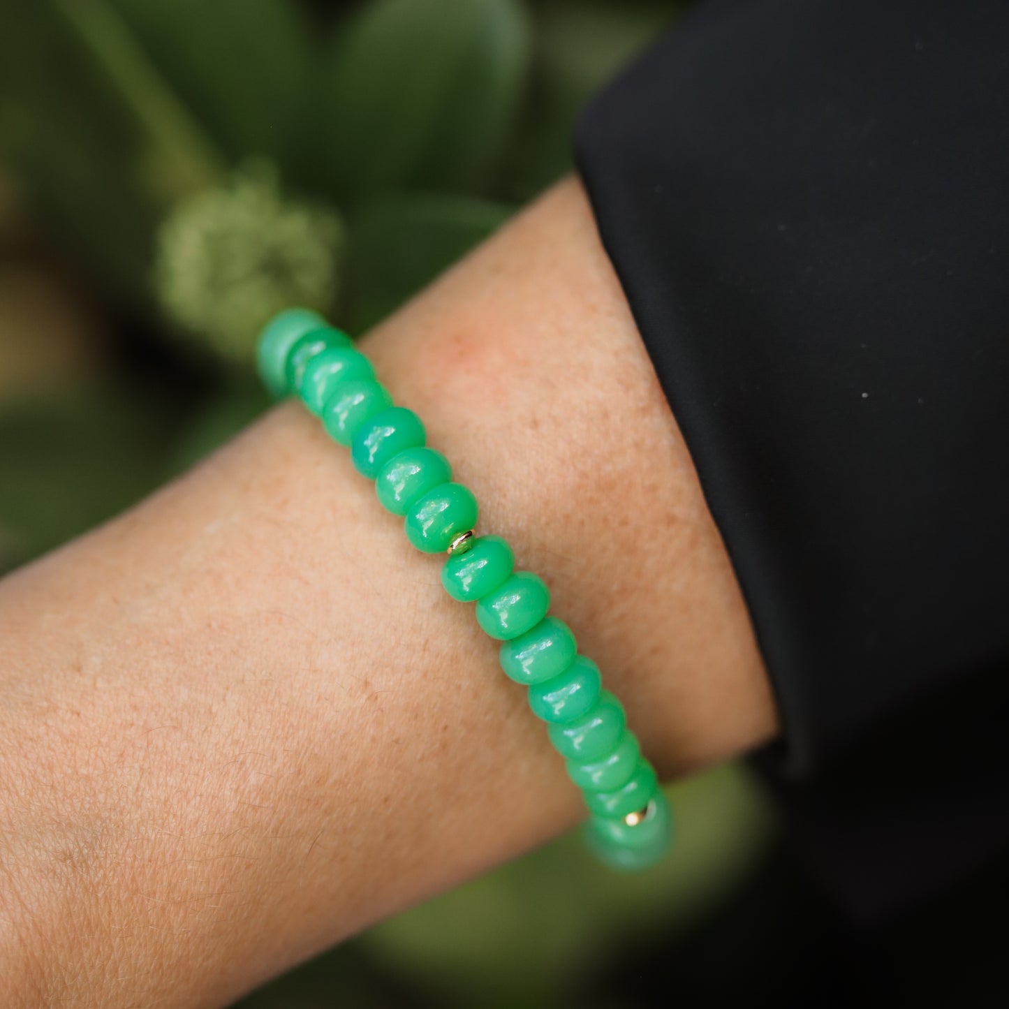 Green Chalcedony bracelet by Earthly Abundance with polished beads, showcasing vibrant green stones on a delicate elastic band.