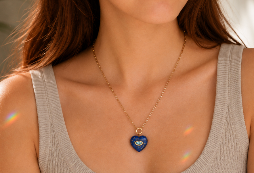Earthly Abundance Midnight Heart Pendant featuring deep blue lapis lazuli and sparkling blue topaz in a heart-shaped design.