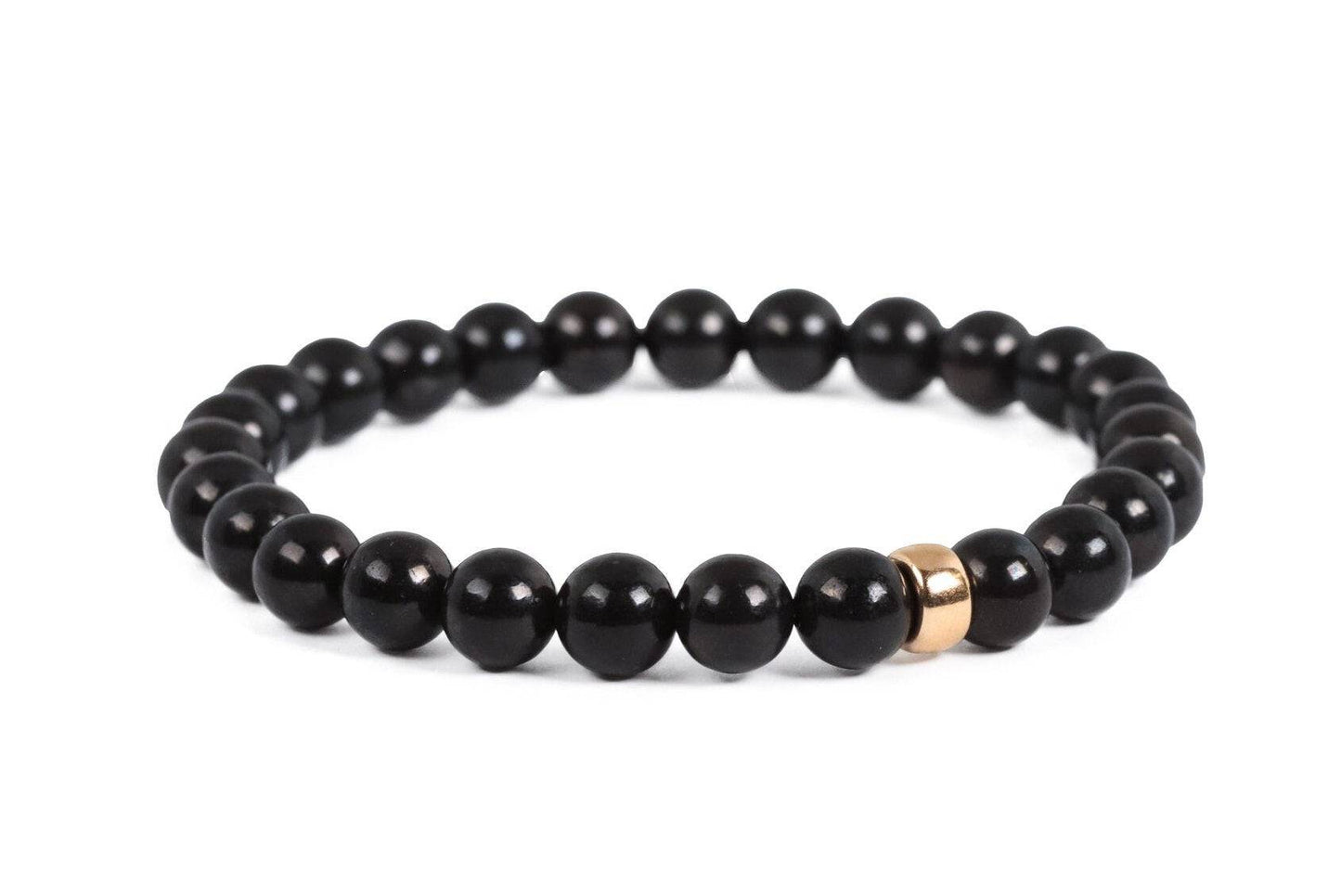 Shungite 6mm bead strand from Earthly Abundance Jewelry featuring polished black stones on a jewelry display.