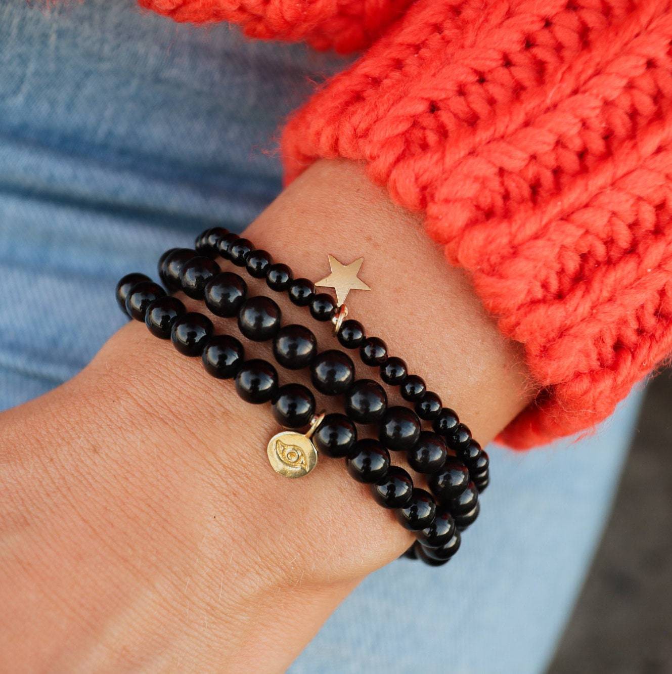 Shungite 6mm gemstone bead strand from Earthly Abundance Jewelry, showcasing smooth, round black stones with a 14K gold clasp detail.