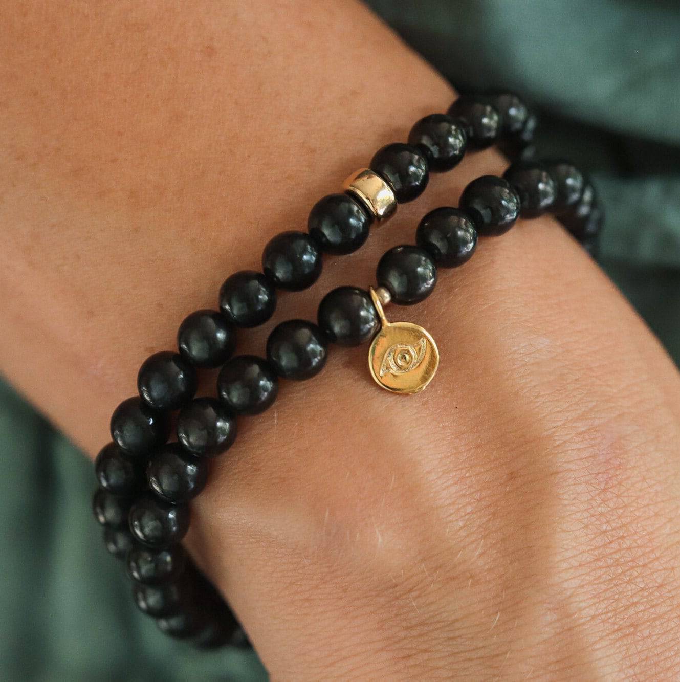 Shungite 6mm gemstone bead strand from Earthly Abundance Jewelry, showcasing polished black stones with 14K gold accents