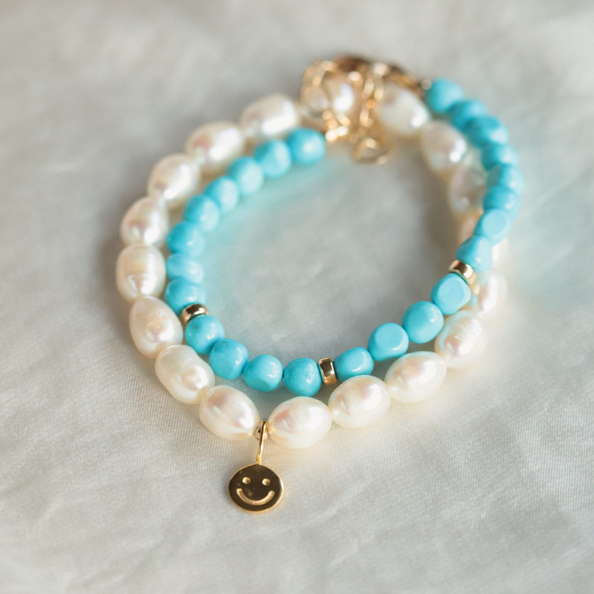 Happy Face freshwater pearl bracelet by Earthly Abundance featuring a playful face charm and lustrous white pearls.