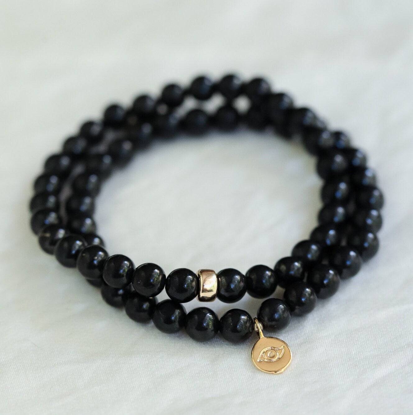 Shungite 6mm bead bracelet from Earthly Abundance Jewelry showing round black stones with a 14K gold clasp.