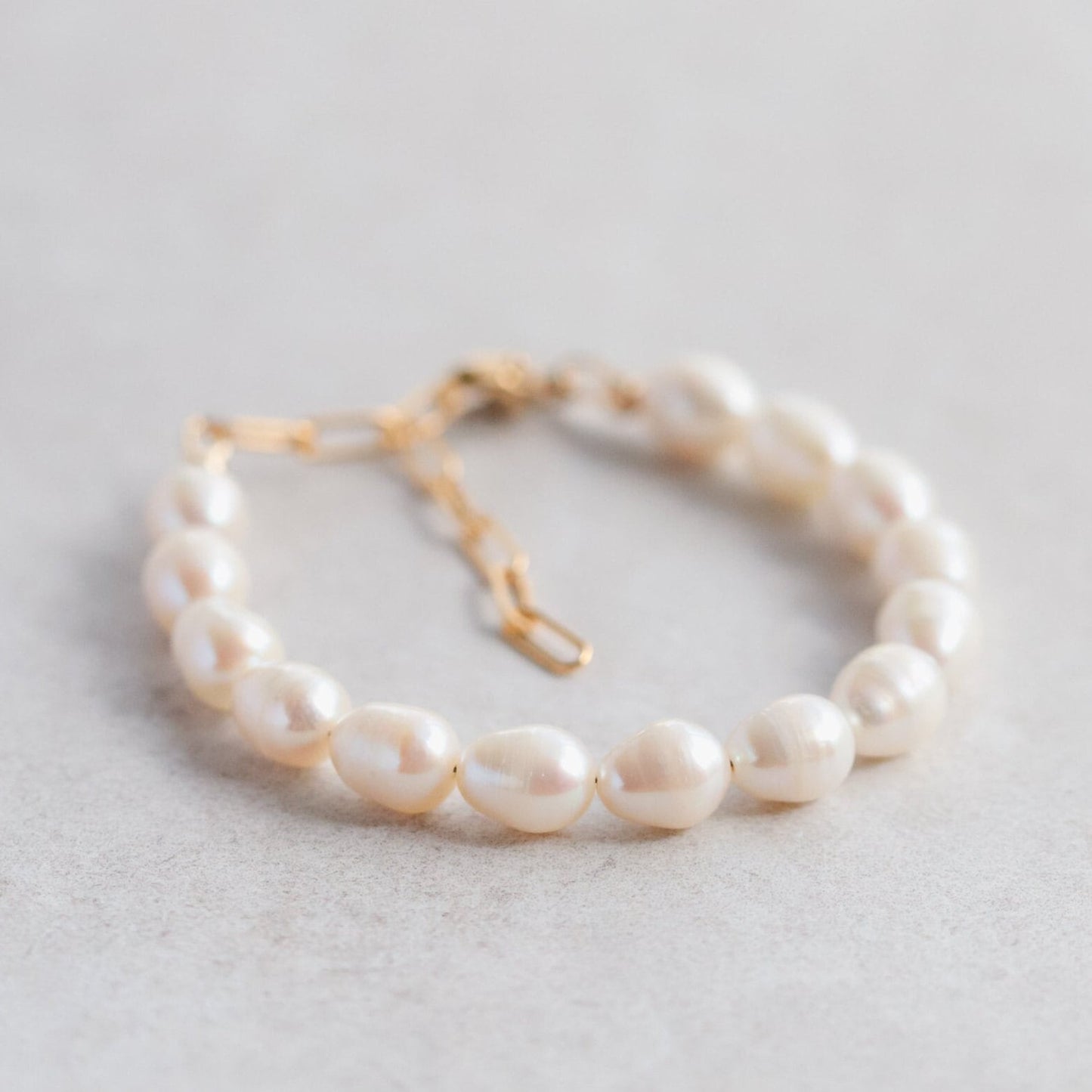 Freshwater pearl bracelet with 14K gold-filled clasp and accents, featuring elegant pearls on a delicate jewelry chain.