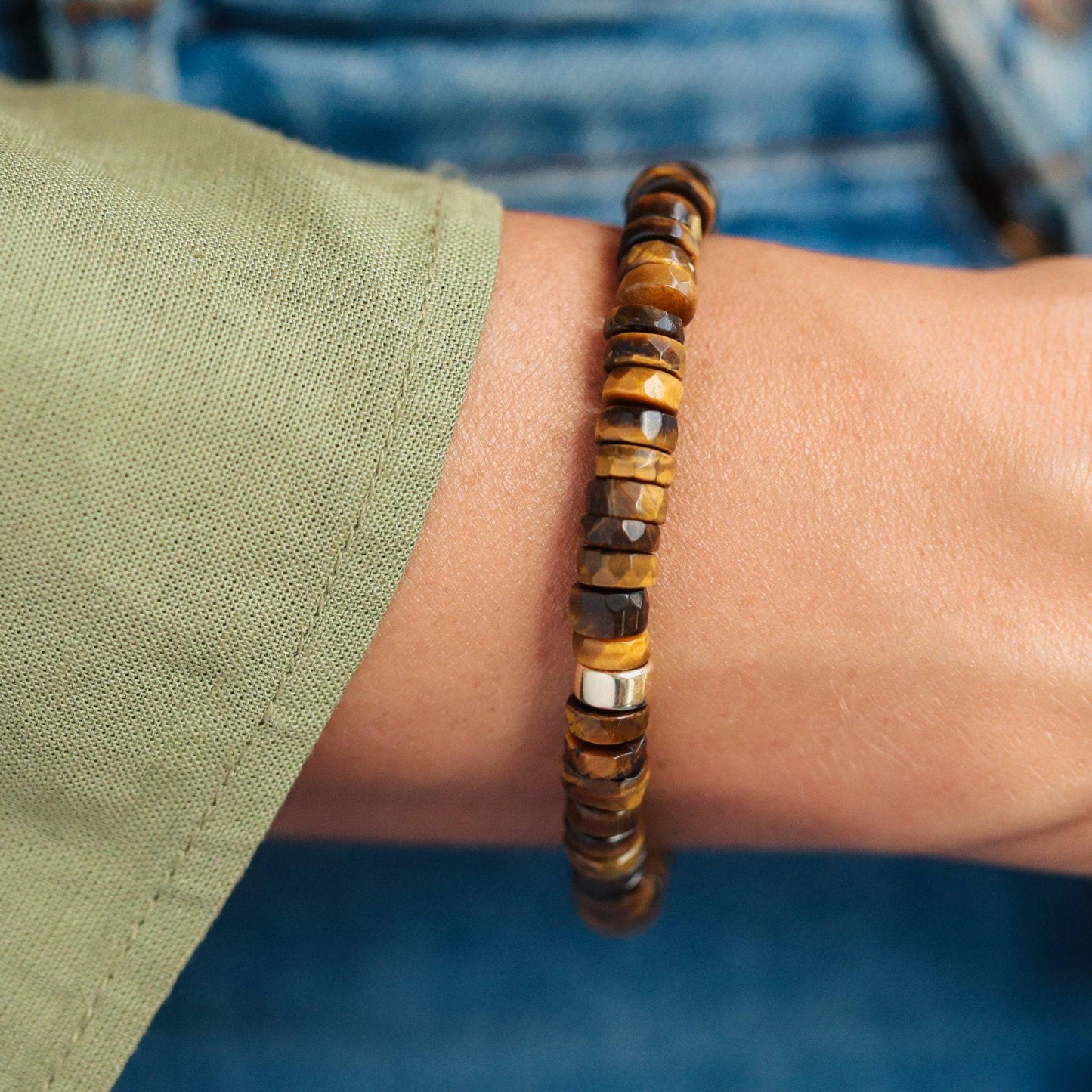 Earthly Abundance Tiger's Eye Heishi bracelet with smooth, round gemstone beads on a stretch cord, showcasing warm, earthy tones.