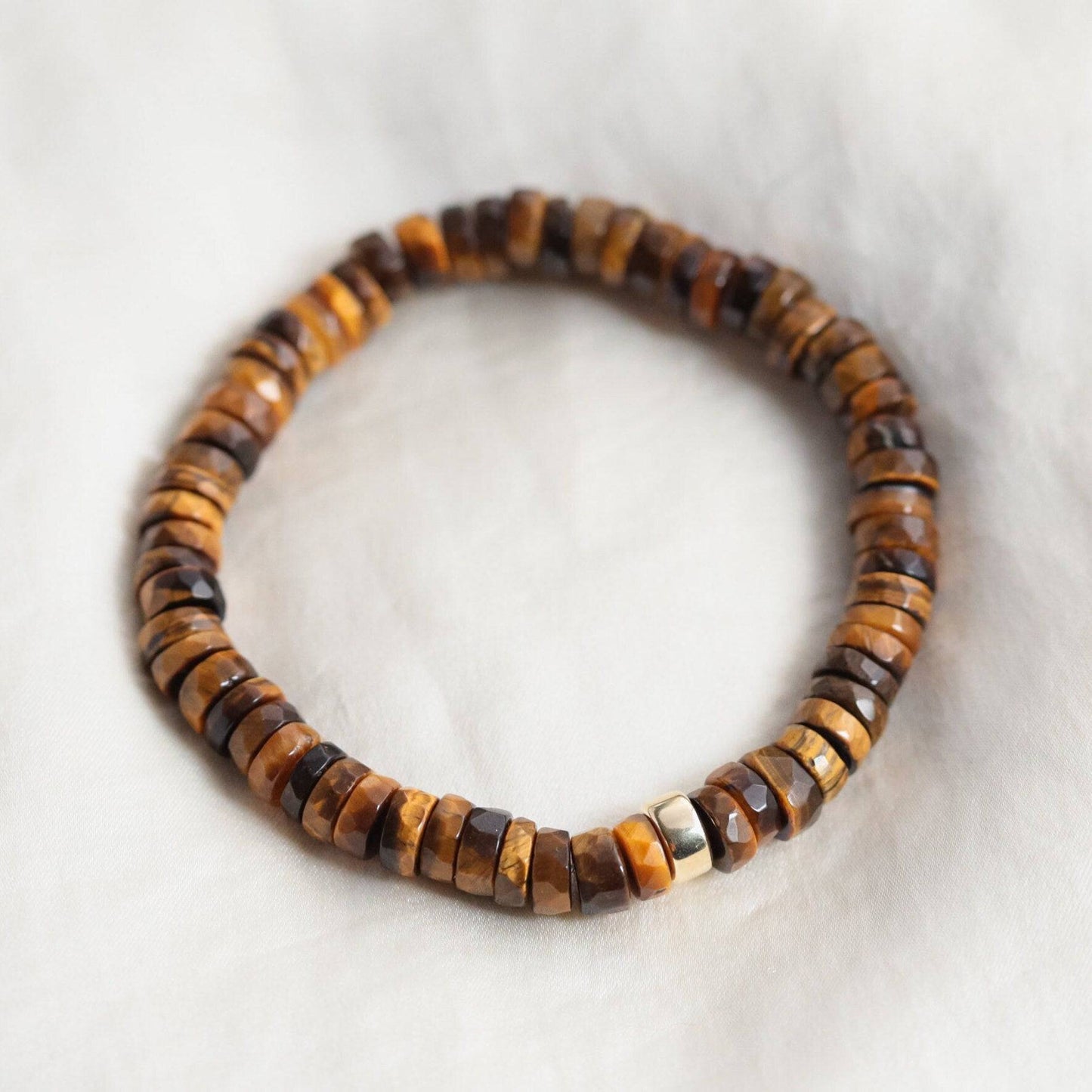 Tiger's Eye Heishi bracelet by Earthly Abundance featuring smooth, round gemstone beads strung on elastic for a stylish, natural look.