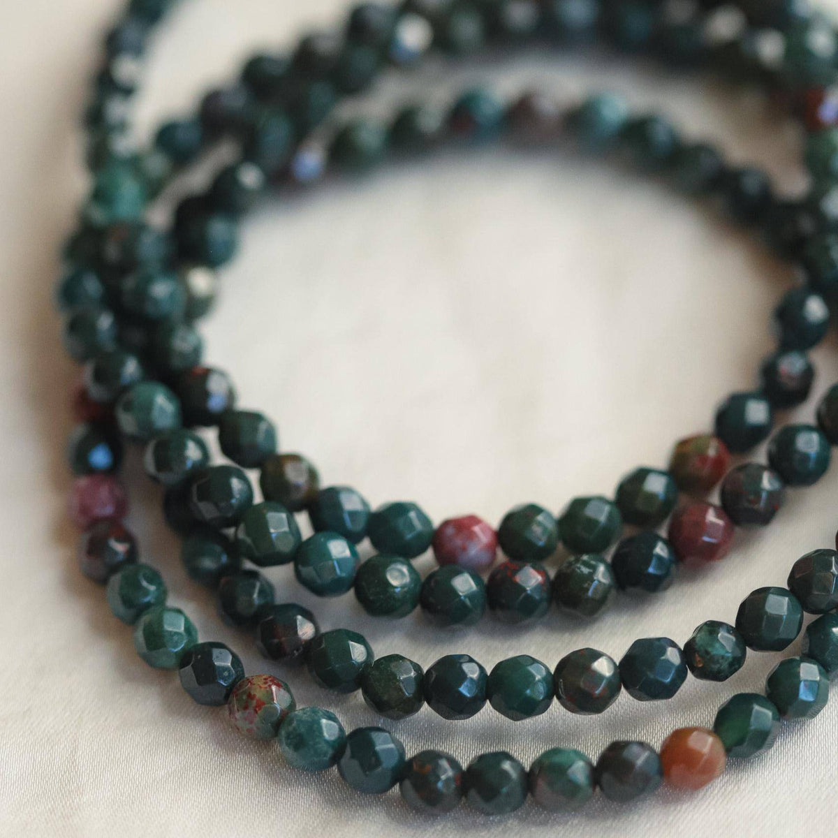 Bloodstone bracelet from Earthly Abundance Jewelry featuring polished beads for protection and intuition.