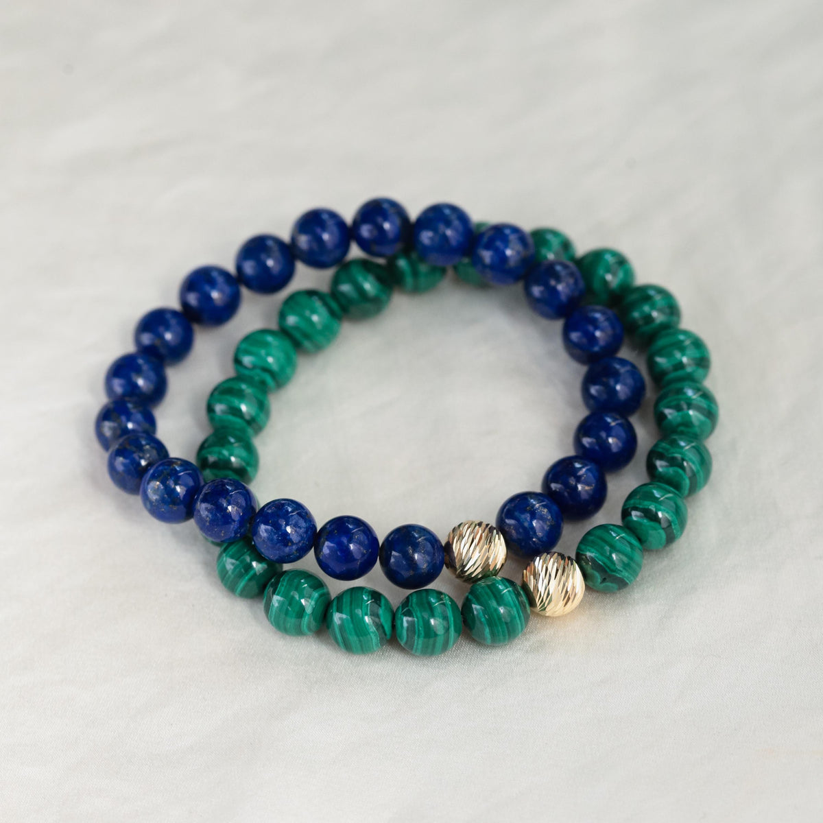 Round 8mm malachite bead from Earthly Abundance, showcasing vibrant green gemstone with natural banding and polished finish.