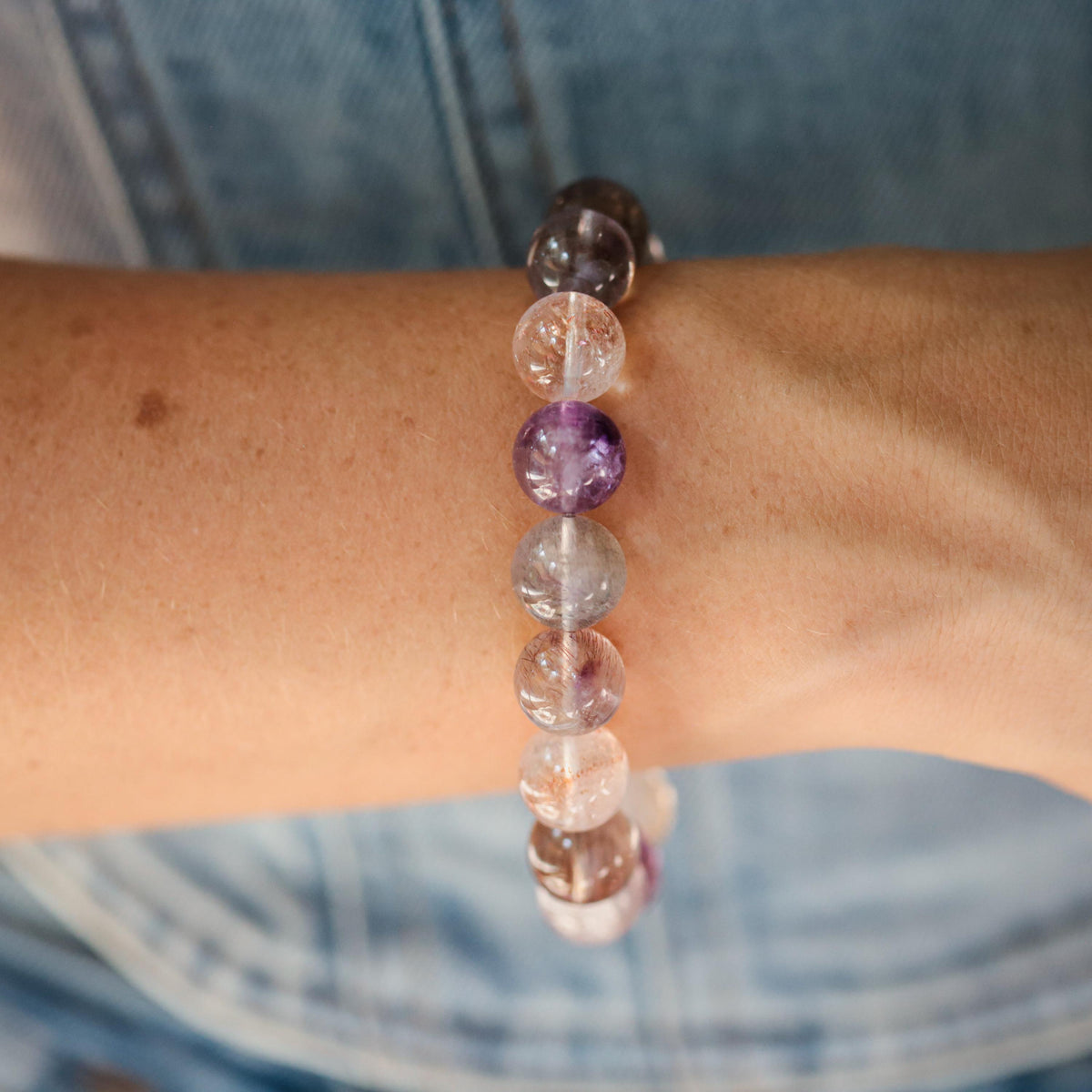 Earthly Abundance AAAA+ Super Seven 13mm mineral gemstone displayed on a white background