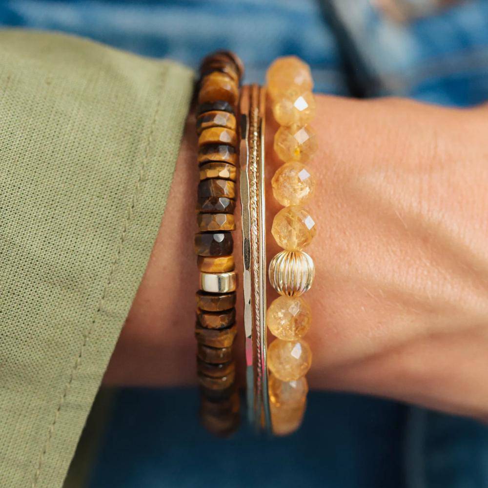 Tiger's Eye Heishi bracelet featuring smooth, round beads strung on elastic for a stylish, natural jewelry accessory.