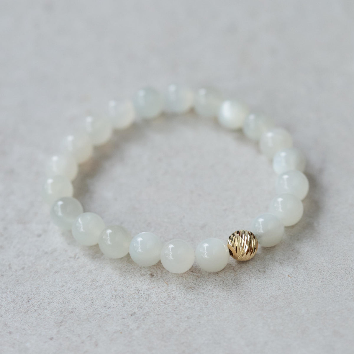 Ethereal Moonstone Bracelet with 14K gold clasp from Earthly Abundance, featuring shimmering moonstone beads on a delicate chain.